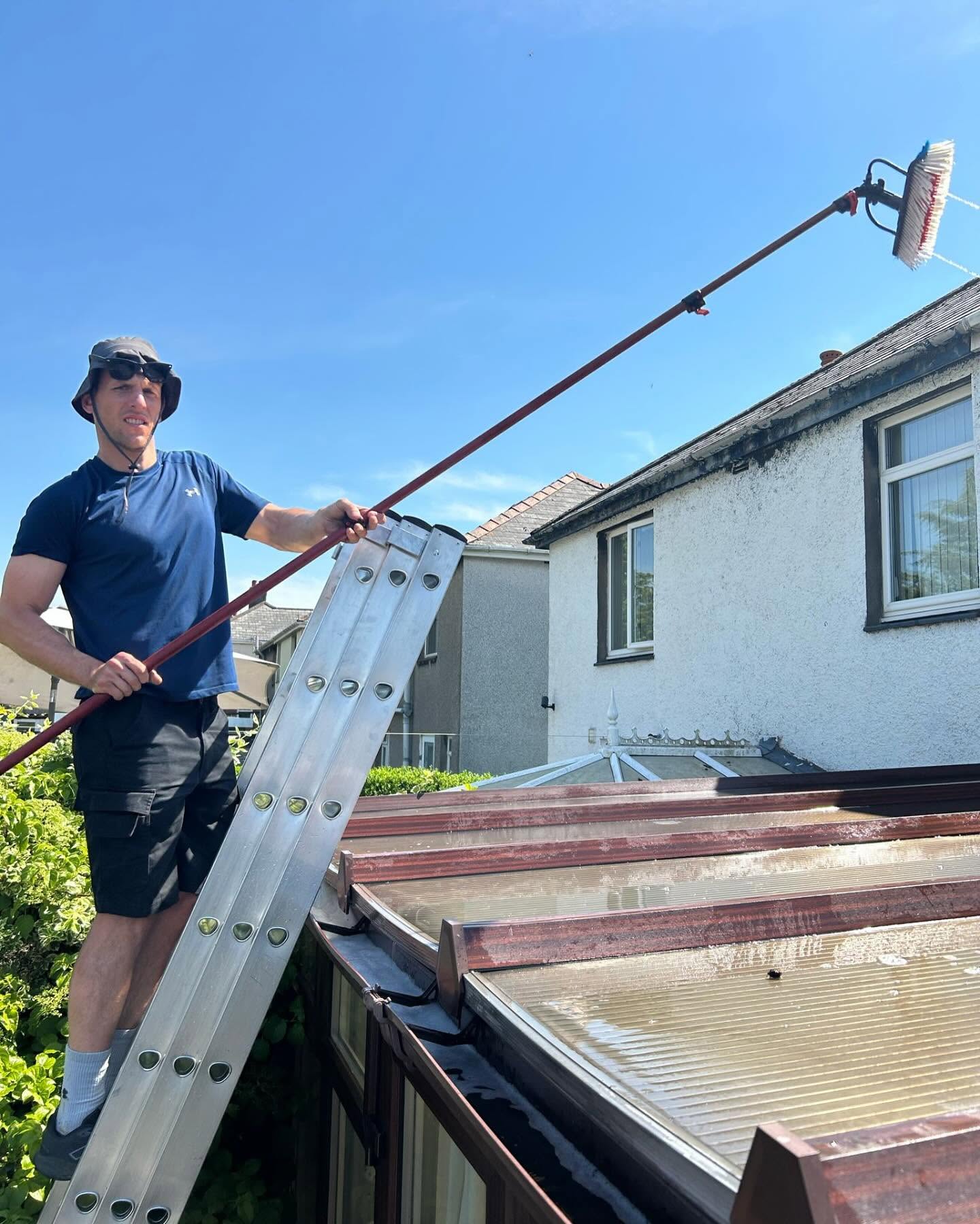 Tom from Marine Clean cleaning a conservatory roof in Caerphilly